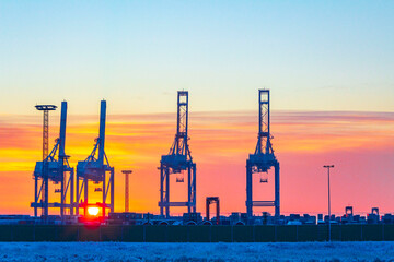Shipyard cranes shipyard crane sunset winter container port Bremerhaven Germany.