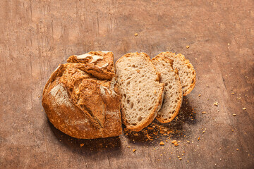 Sliced wholegrain bread on dark ructic wooden background closeup. Fresh bread Top view. .