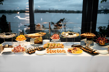 Buffet table of reception with burgers, cold snacks, oysters, meat and salads