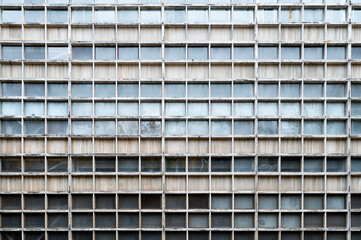 Glass grey square Windows of modern city business building skyscraper. Glass balconies in the building. Modern apartment buildings in new neighborhood. Windows of a building, texture