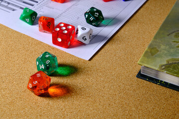 A role-playing book, several role-playing game dice with a role-playing game character token, on...