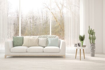 Fototapeta premium White living room with sofa and winter landscape in window. Scandinavian interior design. 3D illustration