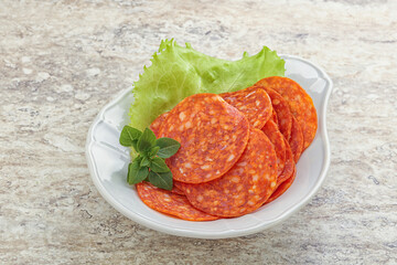 Sliced pepperoni sausage in the bowl