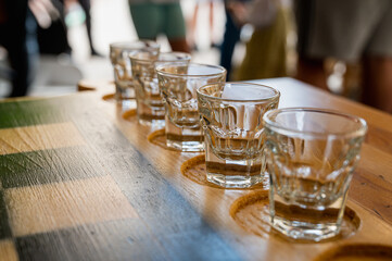 Traditional Georgian dish, khinkali Kalakuri, on wooden table, chess board, rustic, side view, playing chess. Selective focus, side view. glasses for alcohol near the chessboard 