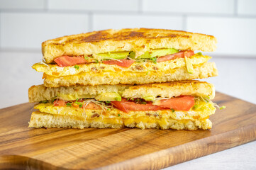 Grilled Omelette Sandwich with Avocado, Tomato, and Sprouts