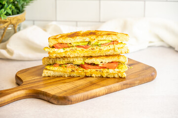 Grilled Omelette Sandwich with Avocado, Tomato, and Sprouts