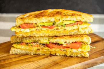 Grilled Omelette Sandwich with Avocado, Tomato, and Sprouts
