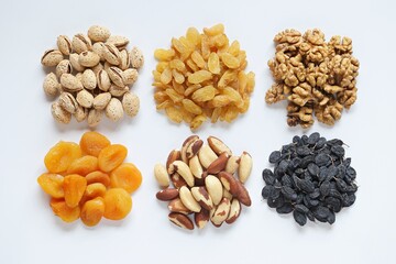 Variety of nuts and dried fruits. Nuts and drid fruits assortment on white background. Flat layot