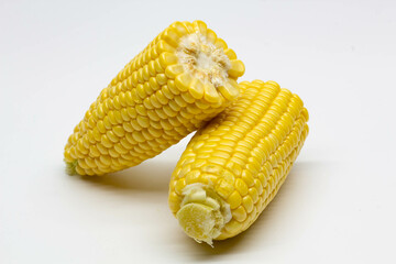 Two halves ear of ripe sweet corn isolated on white background. Isolated. Package design element. Sweet corn without husk. Close-up