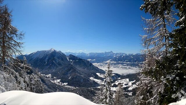 Panoramic view of cold winter wonderland landscape seen from the Bleiberg Erzberg mountains, Gailtal Alps, Carinthia, Austria, Europe. Looking at Karavanks (Karawanken) and Dobratsch Villach Alps