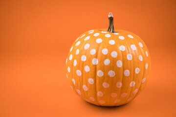 polka dots Orange pumpkin on orange background. haloween concept.