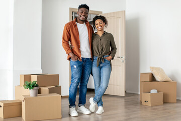 Fototapeta na wymiar African American Spouses Hugging Smiling Standing In New House