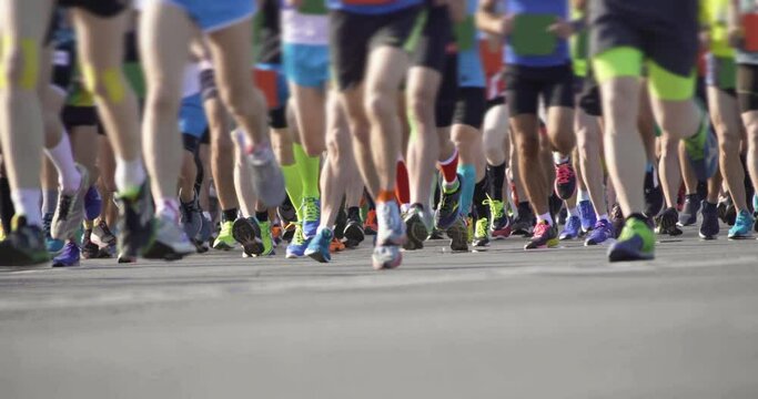 4K - Mass International Marathon Run. Close-up of athletes legs