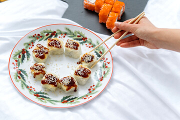 Baked Maki roll with cheese on ceramic plate. Japanese menu concept. 45 view.