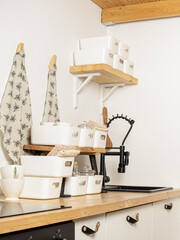 Organizers on kitchen. Set of white plastic organizers for cosmetics, small items, medicines. Order in the kitchen. Vertical