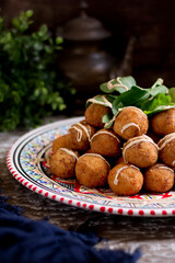 Risotto balls served in a dish isolated n wooden table side view