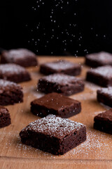 assorted brownie with chocolate and almond isolated on wooden table side view