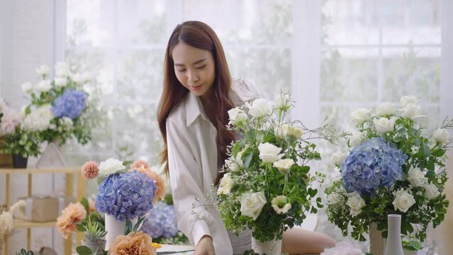 Asian women create lovely floral arrangements to sell.