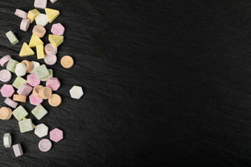 Scattered Tablet Candies on Black, Compressed Tablets
