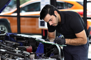 Car mechanic working with a Service checking car engine	