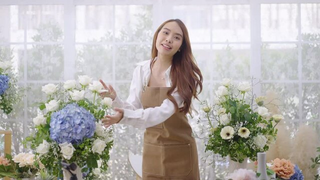Young Asian woman does a live internet presentation for the sale of her flowers from her house.