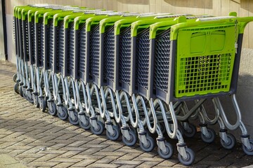 Closeup of green shopping carts in a row