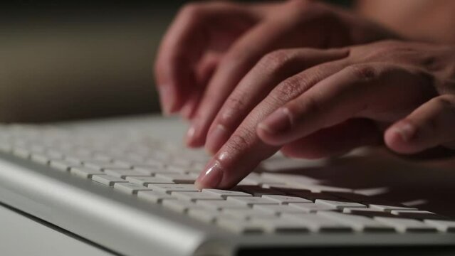 Macro close up of an young businesswoman hands busy working on laptop or computer keyboard for send emails and surf on a web browser.
