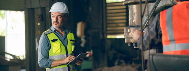 professional industrial engineers in hard hats. working at heavy industry manufacturing factory,...