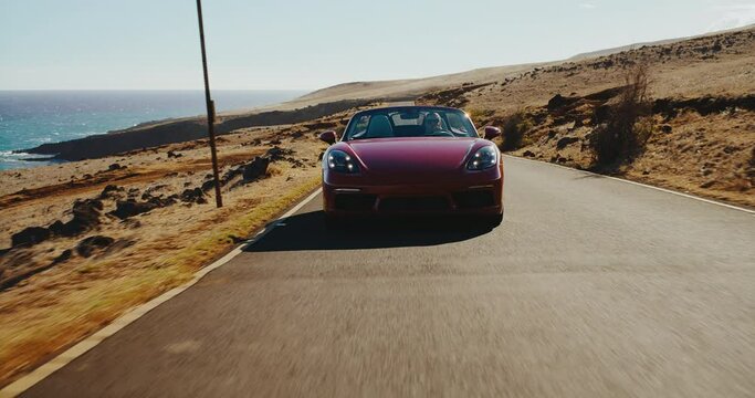 Epic sunset drive, beautiful classic sports car driving on desert road at sunset