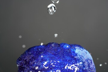 Closeup shot of blue crystal with waterdrops