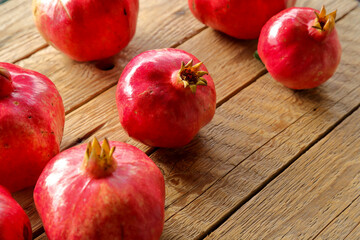 Fototapeta na wymiar organic pomegranates on wooden table