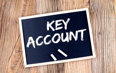 KEY ACCOUNT text on a chalkboard on the wooden background