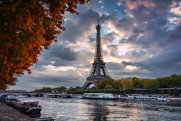 Fototapeta premium Eiffel Tower by the Seine River in Paris at sunrise. France
