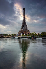 Naklejka na ściany i meble Eiffel Tower by the Seine River in Paris at sunrise. France