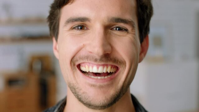 Happy, smile and a man laughing closeup at comedy, joke or good news in home. Comic, laugh and fun, a guy smiling with teeth and open mouth. Crazy, funny and excited freedom for life of happiness.