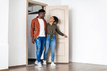 Fototapeta na wymiar Happy Black Husband And Wife Hugging Entering Own House