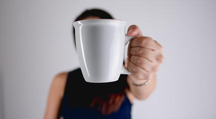 woman holding a coffee tea mug 