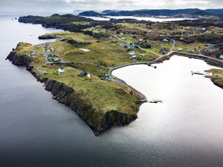 Aerial East Coast and Skerwink trail with small beach homes near Port Rexton Newfoundland Canada
