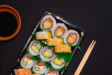 vertical, assorted sushi platter, chopsticks and soy sauce