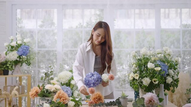 Asian woman make beautiful floral compositions for sale