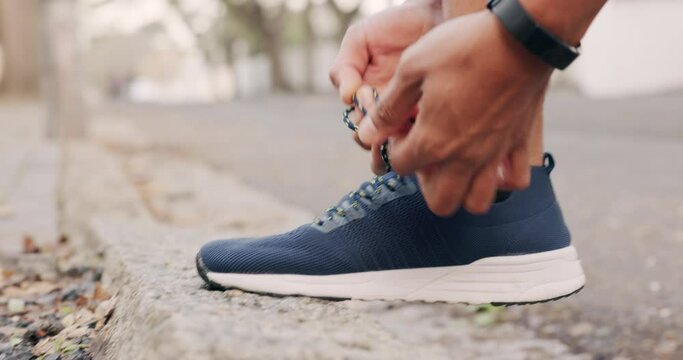 Man runner tie lace of shoes before running, athlete ready and preparing to start run outdoor in the street. Athletic, fitness or sport person training, workout and exercise in the urban road