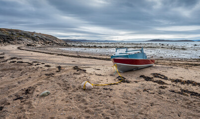 Fishing boat moored in the sand of the Arctic Ocean at Iqaluit