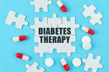 On a blue background, pills, capsules and puzzles with the inscription - DIABETES THERAPY