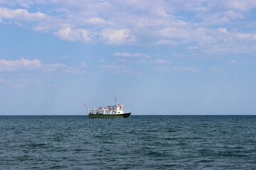 fishing boat in the empty blue sea. Landscape of the sea with a fishing boat 