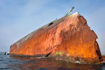 sunken ship, grounded transport ship, rusty skeleton of ship