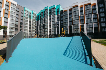 beautiful courtyard and modern playground behind a fence in an apartment building