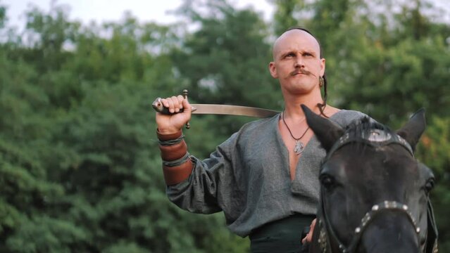 Cossack Rider on a horse. Zaporizhian Cossack with a saber on horseback. Ukrainian ancient warrior. Soldier. Infantryman. Cavalry. Strong people.