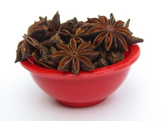 Star anise in a bowl on white background 