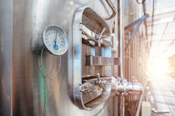 Thermometer or pressure gauge on fermentation vat in modern winery