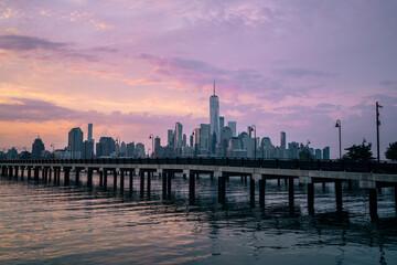 Fototapeta na wymiar city skyline at sunset colors beautiful sky violet magic sunrise pier bride river 